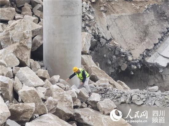 亂石林立、水流湍急，四川公路設計院工作人員不懼危險抵進觀察橋墩受損情況。四川公路設計院供圖